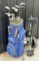 Front view of golf bag with clubs and push cart