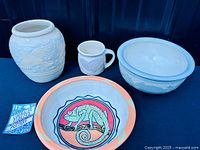 Group shot of four Lorraine Eidlitz pottery pieces and artist card