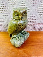 Front view of green serpentine owl carving