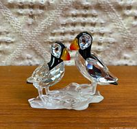 Front view showing two crystal puffins on frosted base