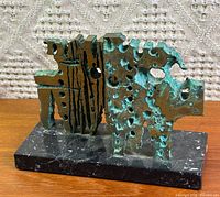 Front view showing abstract form and patina