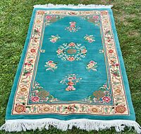 Full view of teal Chinese Art Deco rug with fringe