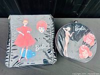 Overall view of two Barbie vinyl cases