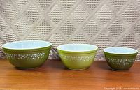 Front view of all three Pyrex Spring Blossom Green bowls nested side-by-side