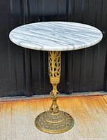 Full view of brass pedestal plant stand with marble top