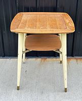 Front view showing square top, legs, and shelf