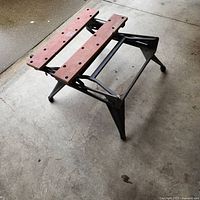 Overall view of folded workbench on garage floor