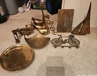 Group shot of all brass items on carpet