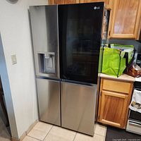 Front view of stainless LG Instaview side-by-side refrigerator