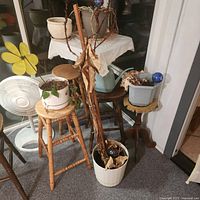 Group view of pots, pitcher, decor on stools and floor