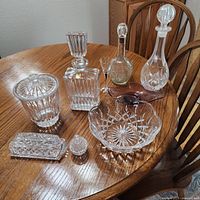 Group shot displaying all eight glass items on wooden table
