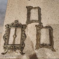 All three brass picture frames on countertop
