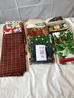 All folded Christmas cotton fabric pieces laid out on table