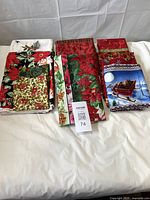 Group shot of all folded Christmas cotton fabrics on table