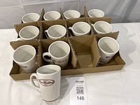 Tray with 12 Tim Hortons mugs separated by cardboard dividers