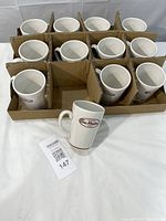 Full set of 12 mugs in cardboard divider, one mug displayed in front