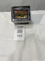 Ornament in presentation box with lot tag visible