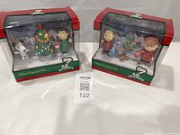 Both boxed Peanuts mini figure sets side by side