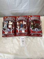 All three packaged figures side by side on table