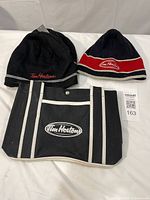 Front view of two Tim Hortons knit toques and canvas tote bag