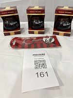 Three boxed coffee pot ornaments and packaged keychain