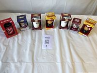 Seven boxed Tim Hortons ornaments lined on table