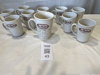 Group shot of ten Tim Hortons mugs showing nine small and one large