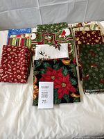 All folded Christmas fabrics displayed on table