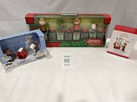 Three boxed Peanuts Christmas items displayed