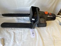 Full view of Remington electric chainsaw with bar cover attached