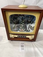 Full front view showing wooden TV cabinet with winter scene inside