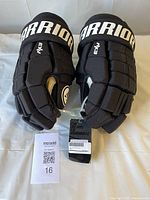 Top view of both gloves showing Warrior branding and attached tags