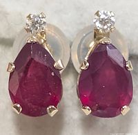 Front view of both earrings showing ruby and moissanite stones