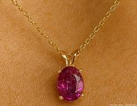 Pendant on chain worn to show scale and appearance