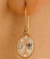 Earring worn on ear showing size and design