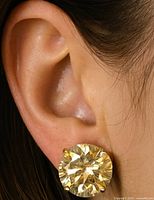 Earring worn on ear showcasing size and setting