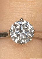 Close view of round brilliant lab diamond in four-prong setting