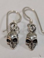 Front view of both skull earrings on hooks