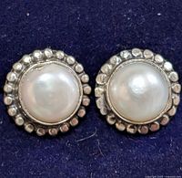 front view of both silver pearl stud earrings