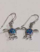 Front view of both earrings showing turtle design and opalite inlay