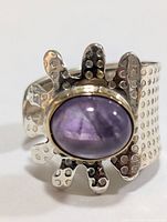 Wide textured silver ring with oval amethyst stone