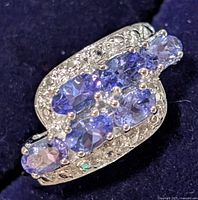 Top view of cluster tanzanite and clear accent stones on silver ring