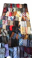 Full overhead view of large assortment of ties arranged in rows