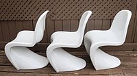 Side view of three white Panton-style chairs showing S-curve profile