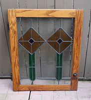 Full view of stained glass window in oak frame