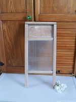 Front view of wooden washboard with ribbed glass panel