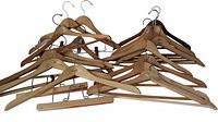 Pile of assorted vintage wooden hangers showing variety and quantity