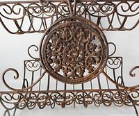 Front view showing two-tier structure, scrollwork, central medallions