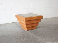 Front angle view of oak stacked pedestal table with smoked mirror top