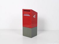 front view of Canada Post letter box coin bank showing Mail Poste label and coin slot